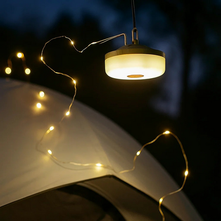 String lights 10meters draped over a tent with a lamp above, set against a dark background