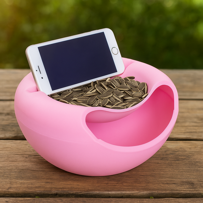 Pink container with coins and a smartphone on a wooden surface