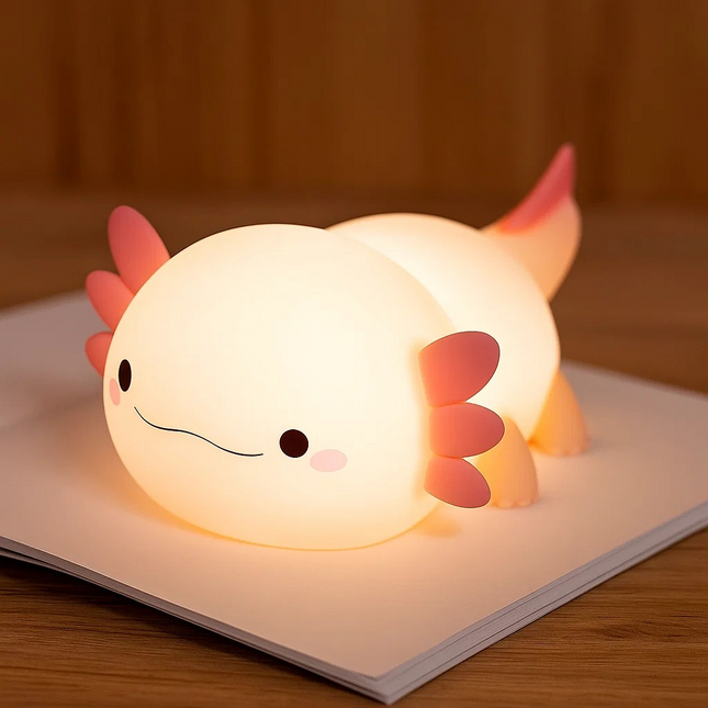 Cute axolotl-shaped night light on a wooden surface with a warm glow.