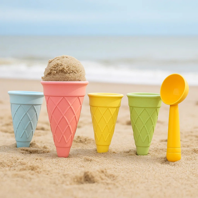 sand toys Colorful sand cones and scoop on a sandy beach with ocean in the background