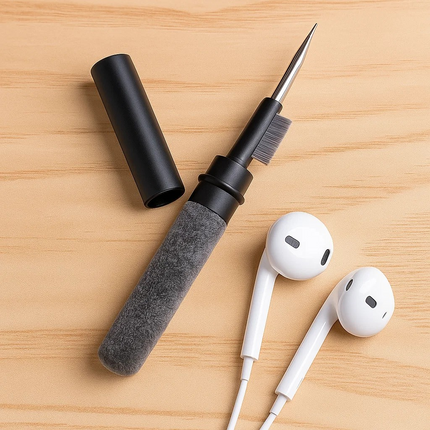 Cleaning tool with brush and white earbuds on a wooden surface