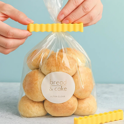 Hands sealing a bag of bread with a chip style clip