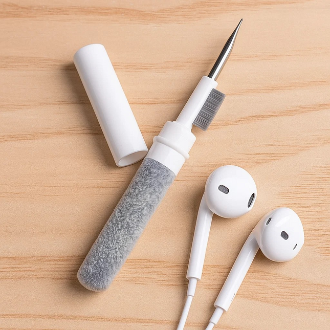 Earbud cleaning tool with earbuds on a wooden surface