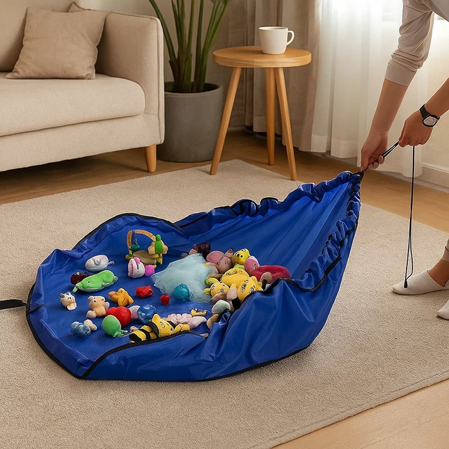 Blue toy storage bag filled with various toys on a beige carpet in a living room.