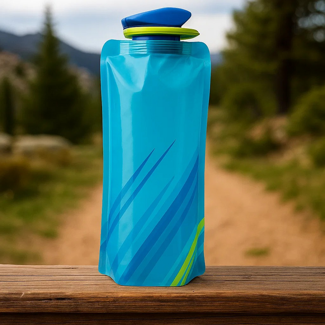 Blue and green collapsible water bottle on a wooden surface with a natural background