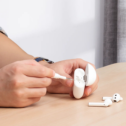 person using a tool to clean earbugs